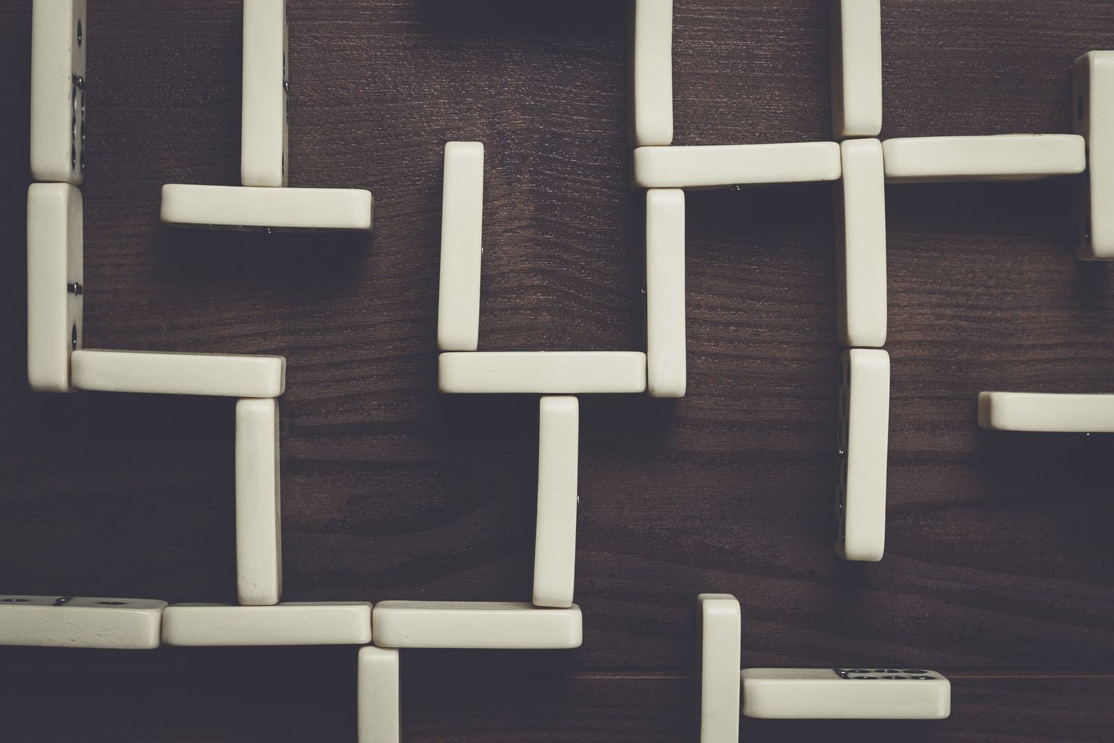 domino pieces maze on wooden table background