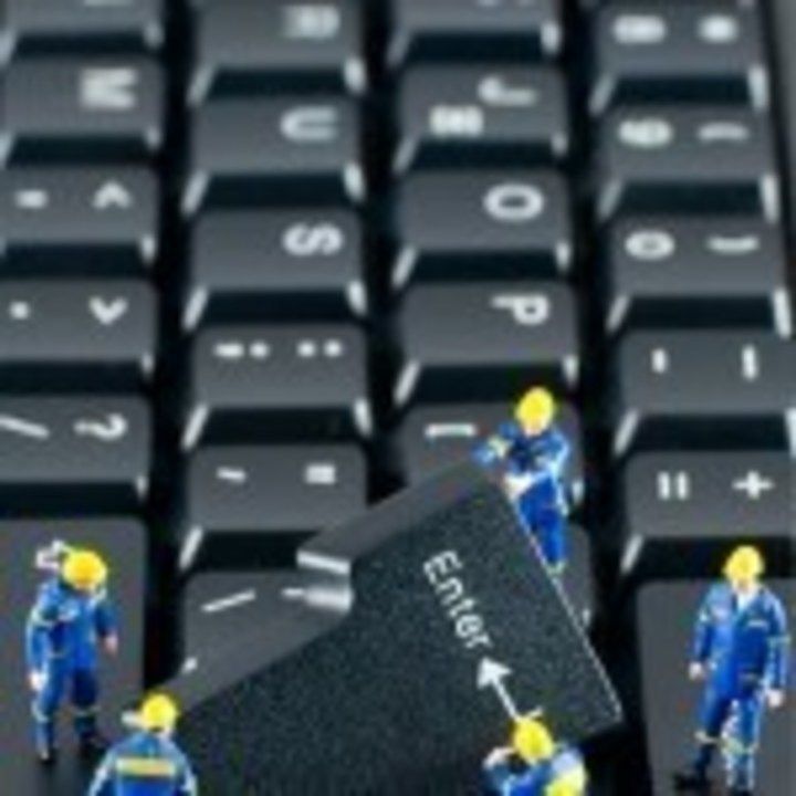 Team of construction workers working on a computer keyboard