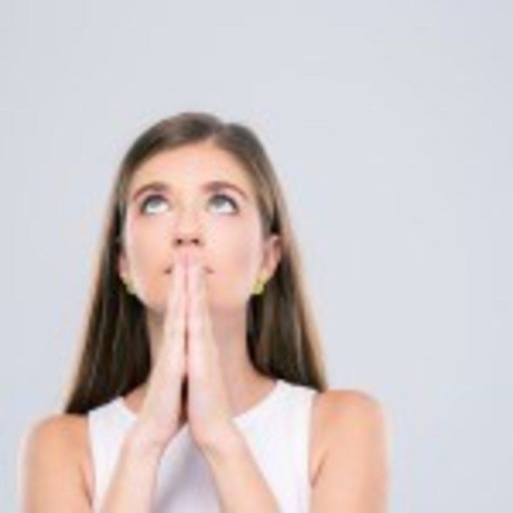 Portrait of beautiful female teenager praying