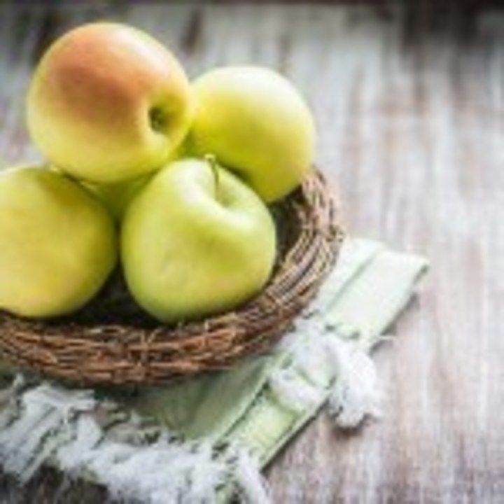 Apples in a basket on rustic background
