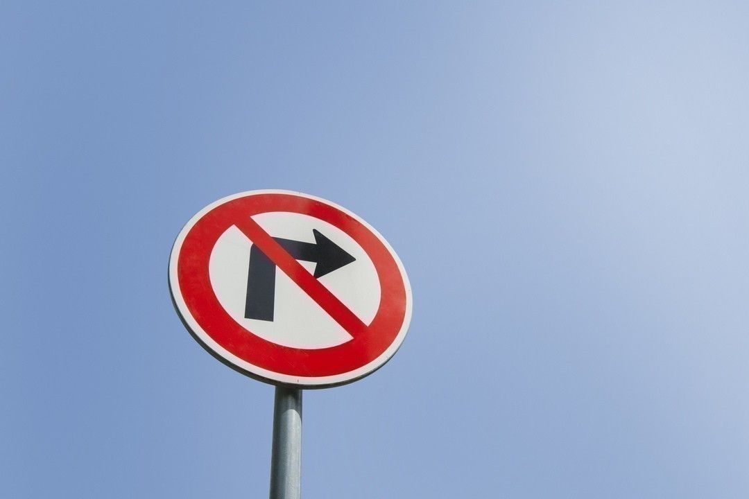 Low angle view of no right turn sign against clear sky