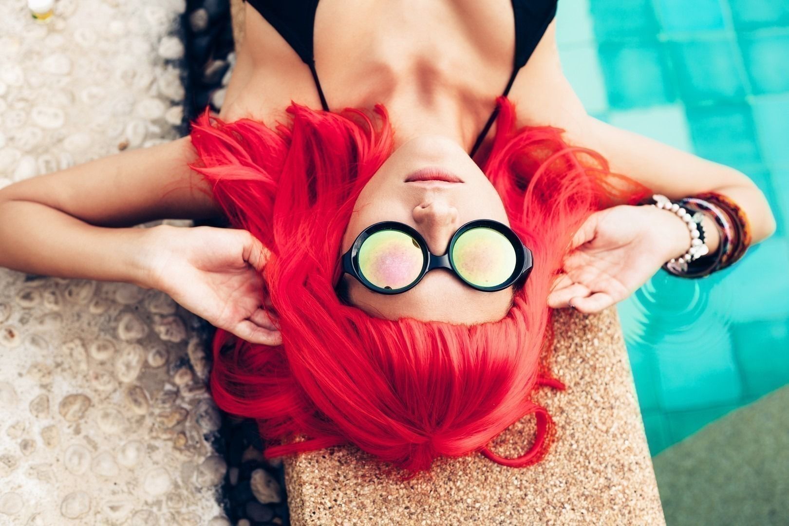 girl with red hair wig in black bikini and sunglasses